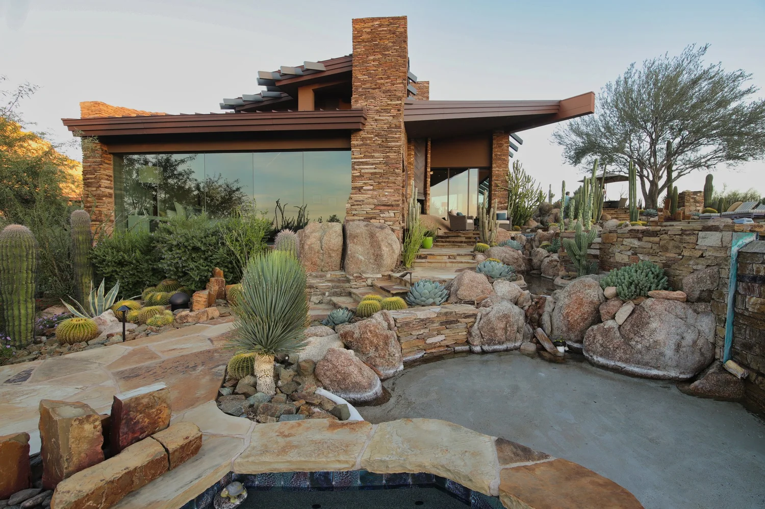 Spa and boulder landscape at a stone desert home